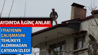 İtfaiyenin çalışmasını, tehlikeye aldırmadan çatıdan izledi